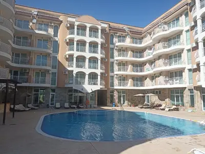 a swimming pool in front of a large apartment building at SilverSprings Lucie in Sunny Beach