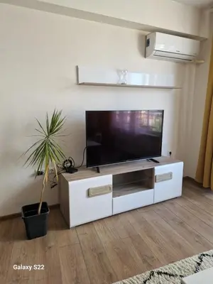 a living room with a flat screen tv on a white entertainment center at De Ja Vu- Zdravez in Burgas City