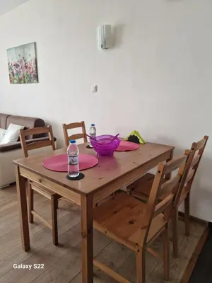 a wooden table with two chairs and a table with two plates at De Ja Vu- Zdravez in Burgas City