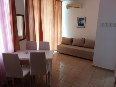 a living room with a table and chairs and a couch at Sunny Beach Apartment, Kokiche Hotel - white building Liliya in Sunny Beach