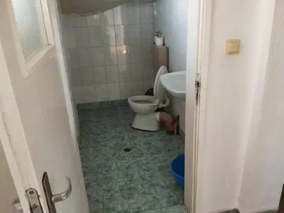 a bathroom with a toilet and a sink at Къща за гости дом Попови Черноморец in Chernomorets