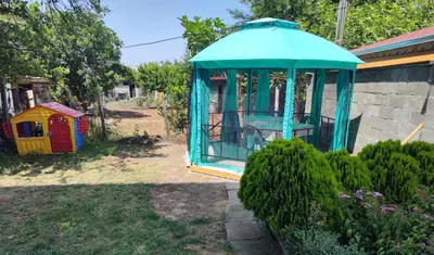 a blue gazebo sitting next to a house at Къща за гости дом Попови Черноморец in Chernomorets