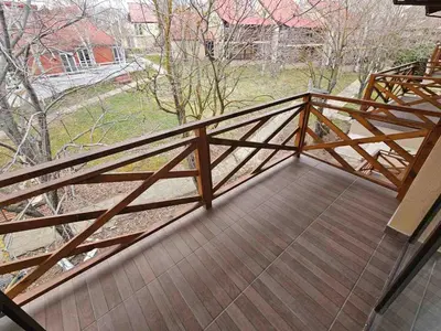 a wooden railing on a balcony with a view at Denevi' seaside apartment - 2 bedrooms in Lozenets