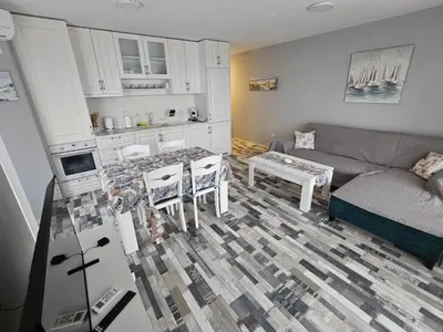 a living room with a couch and a table at Denevi' seaside apartment - 2 bedrooms in Lozenets