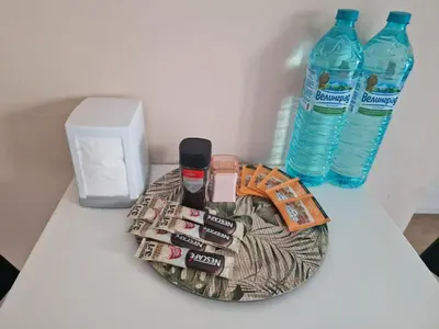 a plate with two bottles of water and a drink at Messembria Resort in Nesebar