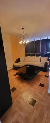 a living room with a large bed on a wooden floor at Unique Apartment with Balcony in Pomorie Old Town by Flat Mаnаger in Pomorie