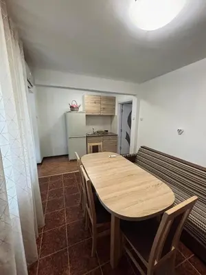 a room with a table and chairs and a kitchen at Вила 50 in Atiya