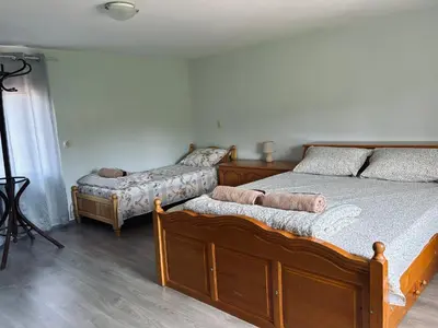 a bedroom with two twin beds and a window at Вила 50 in Atiya