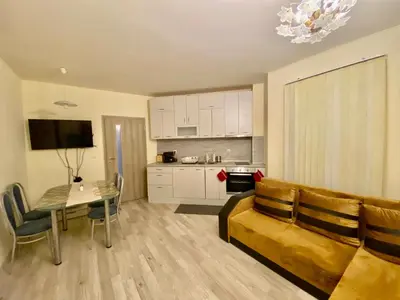 a living room with a couch and a table at Ssenyange Sea View Apartment in Varna City