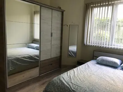 a bedroom with two beds and a large mirror at Ssenyange Sea View Apartment in Varna City