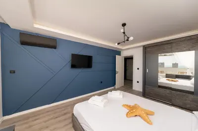 a bedroom with a blue wall with a starfish on a bed at Lazur Sea View in Burgas City