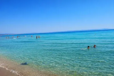 a group of people in the water at the beach at Studiosaltsea in Pomorie