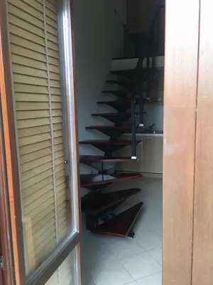 a spiral staircase in a room with a window at Private apartments Ravda-Emerald in Ravda