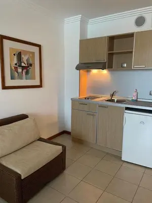 a kitchen with a couch and a sink in a room at Private apartments Ravda-Emerald in Ravda