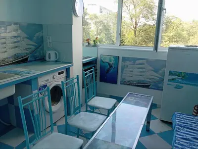 a laundry room with two chairs and a washing machine at Apartament ALBATROS in Burgas City
