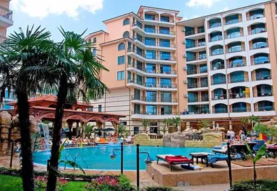 a hotel with a swimming pool in front of a building at Karolina complex appartment in Sunny Beach