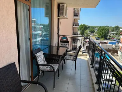 a balcony with a table and chairs on a balcony at Karolina complex appartment in Sunny Beach