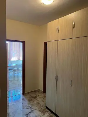 a room with a kitchen with cabinets and a table at Karolina complex appartment in Sunny Beach