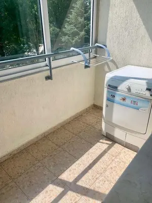 a stove sitting next to a window on a tiled floor at Asinela Home с гараж in Burgas City