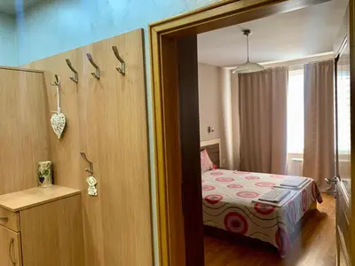 a bedroom with a bed and a door to a room at Asinela Home с гараж in Burgas City
