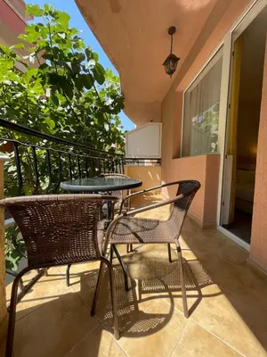 a patio with two chairs and a table on a balcony at Alatoni Beach Hotel in Sozopol