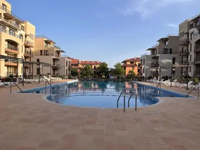 a swimming pool in the middle of some apartment buildings at Sorrento Sole Mare Studio Appartment in Sveti Vlas