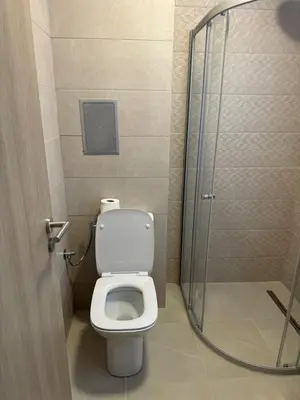 a bathroom with a toilet and a glass shower door at Sorrento Sole Mare Studio Appartment in Sveti Vlas
