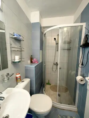 a bathroom with a shower and a toilet and a sink at Blu Bey Pomorie in Pomorie