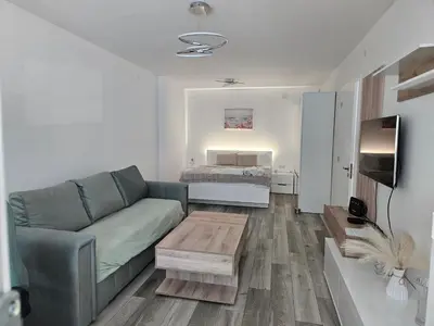 a living room with a couch and a bed at Ann's apartment in Varna City