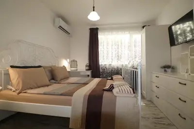 a bedroom with a large bed and a window at Relax apartment with parking in Varna City