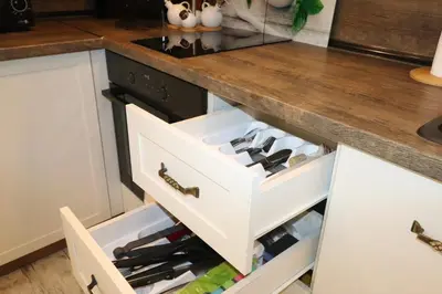 a kitchen counter with a drawer full of wine bottles at Relax apartment with parking in Varna City