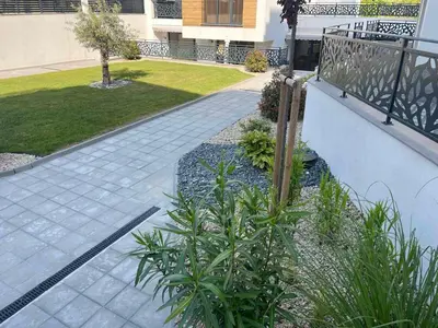 a garden with plants on the side of a sidewalk at Студио Морски дни-топ локация в Созопол in Sozopol