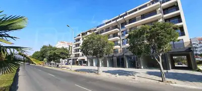 an empty street with trees in front of a building at Apartament Panorama in Pomorie