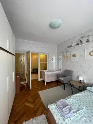 a bedroom with a bed and a living room at BOHO Apartment in Varna City