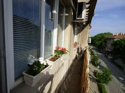 a window with flowerpots on the side of a building at BOHO Apartment in Varna City
