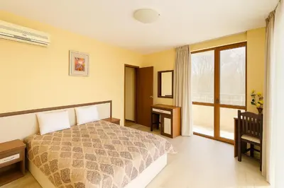 a bedroom with a bed and a window at Sunny Beach Victoria Penthouse in Sunny Beach