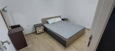 a small bedroom with a bed and a night stand at Marina bay in Sveti Vlas