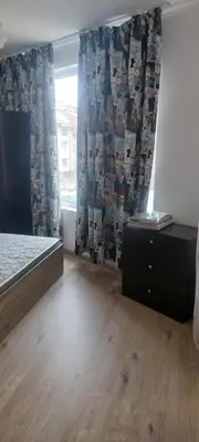 a bedroom with a bed and a dresser and a window at Marina bay in Sveti Vlas