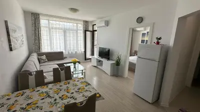 a small living room with a couch and a refrigerator at Apartament Diana in Pomorie