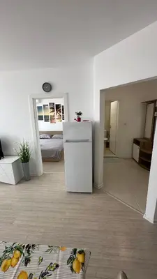 a white refrigerator in a room with a kitchen at Apartament Diana in Pomorie