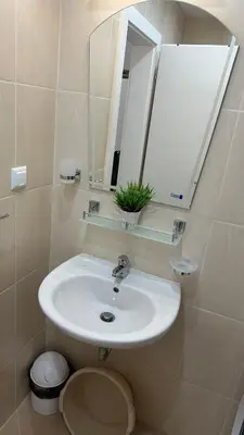 a bathroom with a sink and a mirror at Apartament Diana in Pomorie