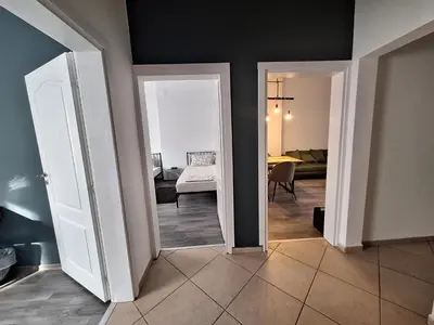 a room with two doors and a room with a bedroom at Apartment Black Sea Center 1 in Varna City