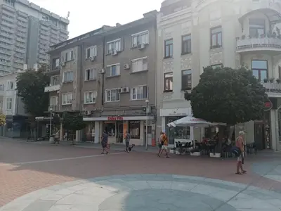 a group of people walking on a street in front of buildings at Apartment Black Sea Center 1 in Varna City