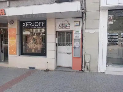 a store front with a red door on a street at Apartment Black Sea Center 1 in Varna City