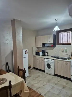 a kitchen with a sink and a washing machine at Делукс Апарт Вергиеви in Burgas City