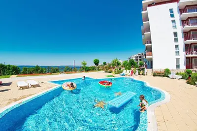 a swimming pool with a water slide in a resort at Fort Noks Panorama in Elenite