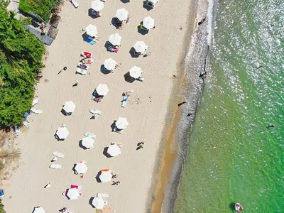 a group of people on a beach with umbrellas at Fort Noks Panorama in Elenite
