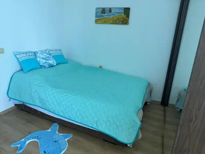 a bedroom with a bed with a dolphin on the floor at Stunning seaview - 50m to the beach in Byala