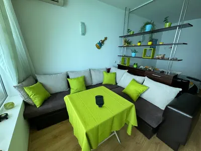 a living room with a couch and a table at Stunning seaview - 50m to the beach in Byala