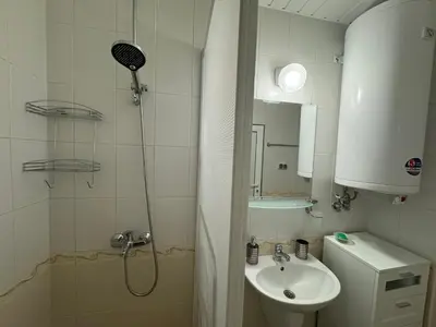 a small bathroom with a shower and a sink at Stunning seaview - 50m to the beach in Byala